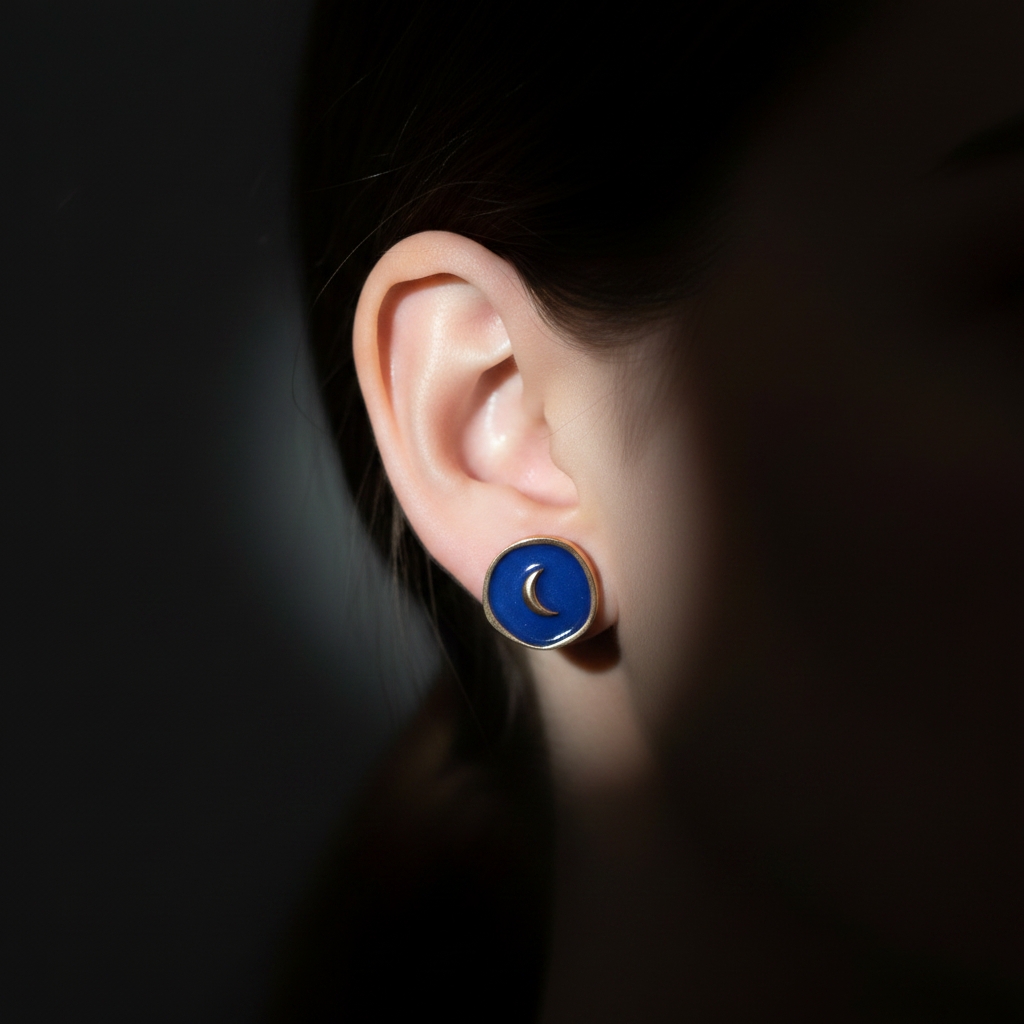 Luna Crescent Earrings close-up on ear with moonlight